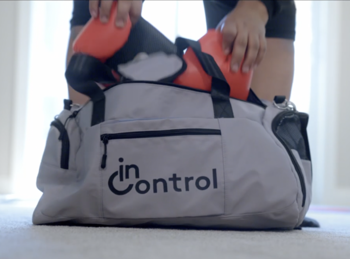 InControl duffle bag with boxing gloves coming out of it